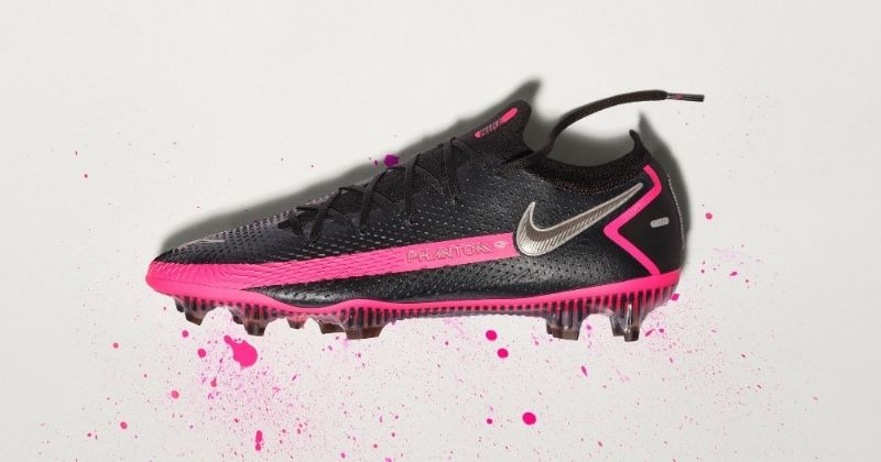 nike phantom gt elite football boots in black and pink on grey background