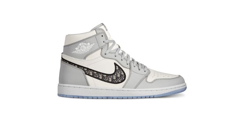 Dior x Nike Air Jordan 1 High OG in white and light grey with black swoosh on white background