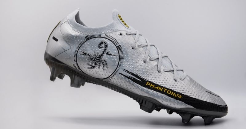 nike phantom gt scorpion football boots floating in silver on grey background