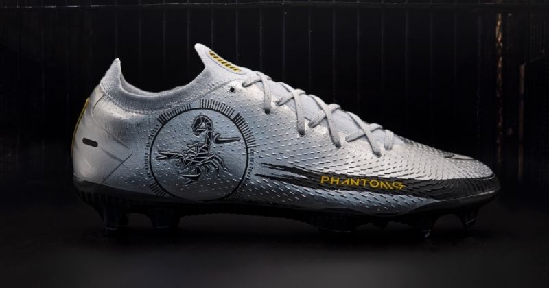 nike phantom gt scorpion football boots in silver on black background