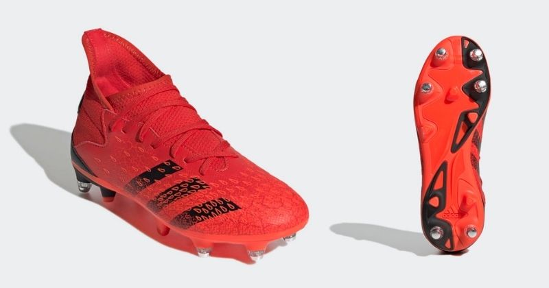 kids soft ground football boots in red showing studs