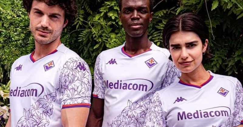 three players wearing fiorentina 2023-24 away shirt in white with purple flowers