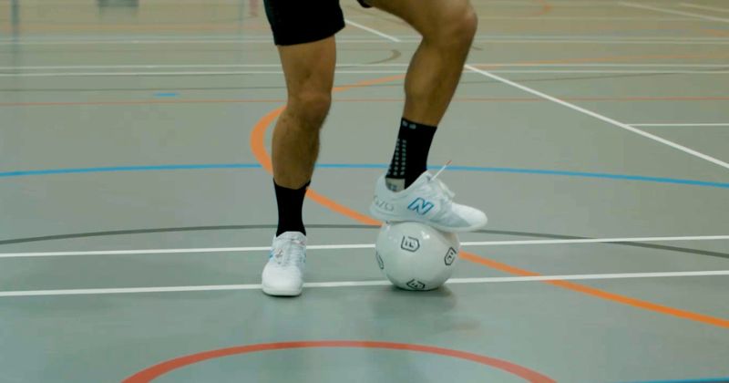 man playing football on indoor football court