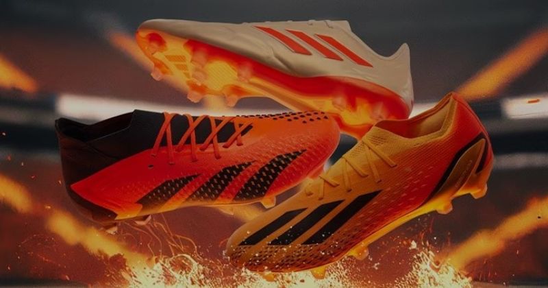 three different adidas football boots in orange with flames