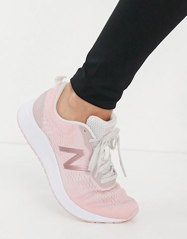 pink and white new balance shoes