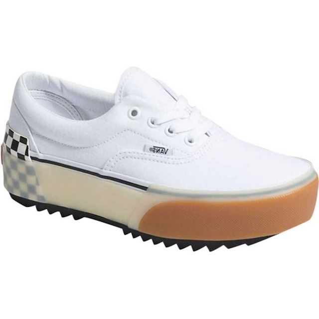 stacked white trainers